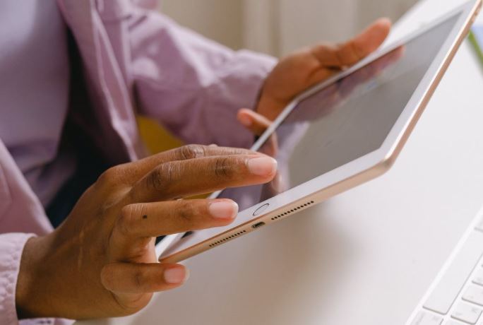 Image of a person holding a tablet.
